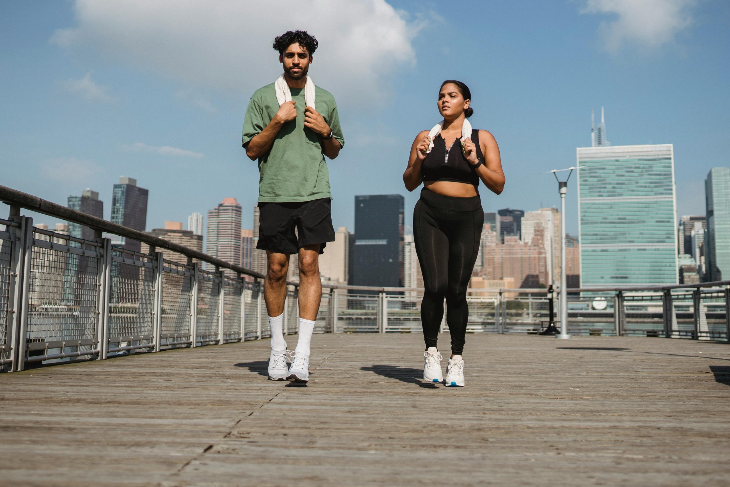 Two people walking to a gym class